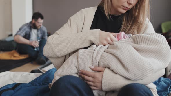 Woman Feeding Baby with Bottle