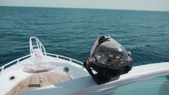 A Navigation Compass on a Yacht in the Open Ocean. Against the Background of the Blue Sea