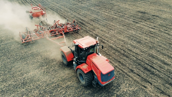 The Tractor Moves Across the Field. Aerial, Top View