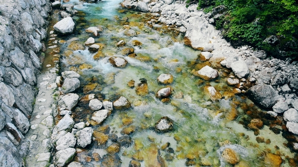 View From Above of a River Spring Washing Bottom Rocks