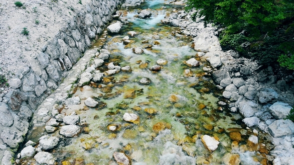 Water Spring Is Going Down the Rocks in a Forest. Water Rushing Through River.