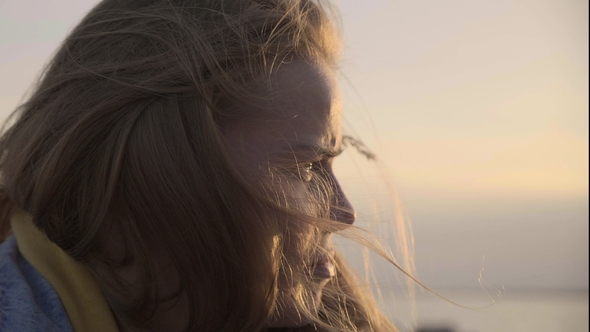 The Face Portrait of Unhappy Adult Girl at Sunset