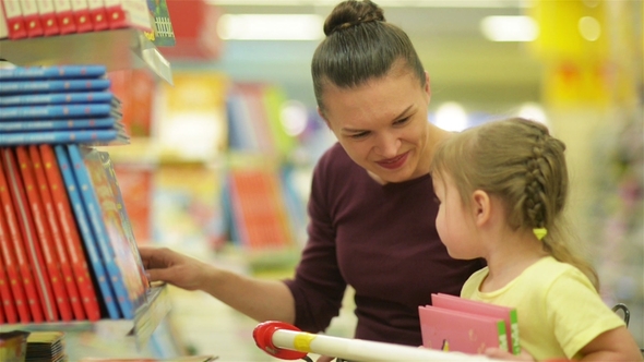 Sweety Daughter Showing To Her Mother A Book. A Daughter Wants To Buy This Book with Illustrations