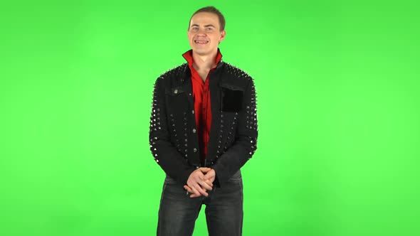 Guy Stands Worrying in Expectation Then Smiles with Relief, Carried. Green Screen