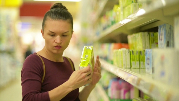 Young Women Chooses Wipes From Supermarket Shelf. A Girl with Caucasian Appearance Makes Purchases