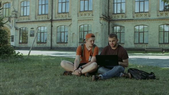 College Students Working on Laptop on Campus Lawn