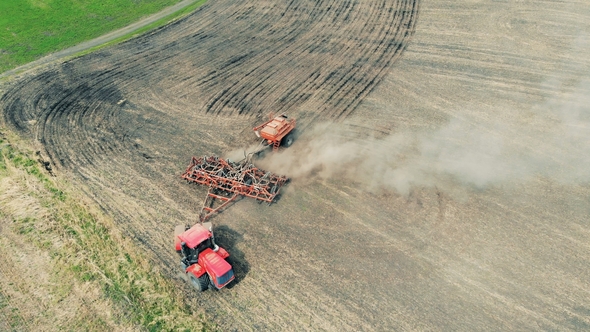 Tractor in a Field. Aerial View. Healthy Food Production Concept