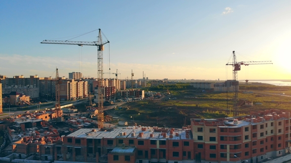 Many Cranes on Construction Sites. Construction of Multi-storied Buildings. Aerial.