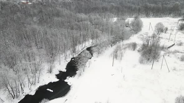 Christmas Fantastic Snowy Landscape with a Nonfreezing River Aerial View