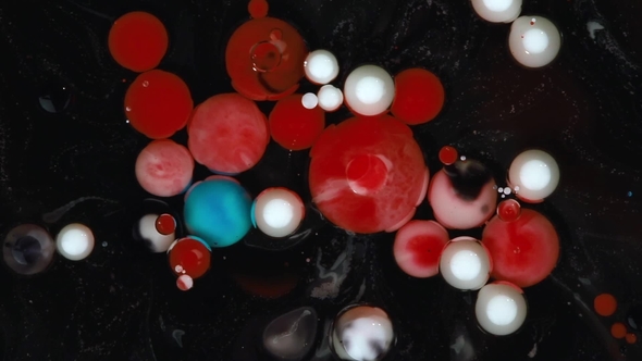 Abstract Background. Acrylic Red, White and Blue Bubbles Mixing in Oil on Black