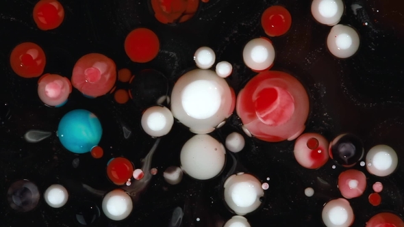 Abstract Background. Acrylic Red, White and Blue Bubbles Mixing in Oil on Black