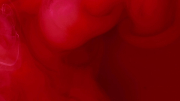 Abstract Background. Red Ink Reacting in Water Creating Abstract Background.