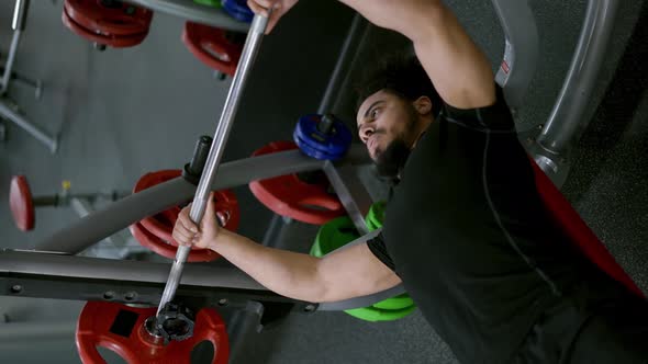 Man with Muscular Physique Spends Hard Workout Lifting Barbell in Gym Slow Motion