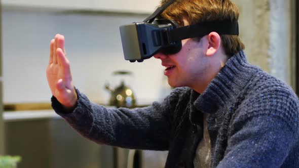 Man using virtual reality headset at home