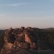 Aerial View of the Three Friends Sitting on Top of the Mountain and Watching the Sunset - VideoHive Item for Sale