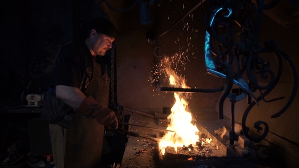 Blacksmith Melts Metal in Furnace