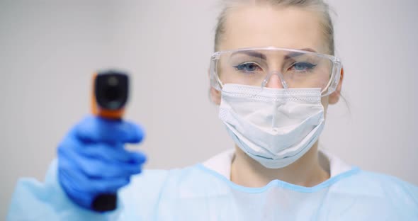 Doctor Measuring Patient Temperature at Health Care Clinic