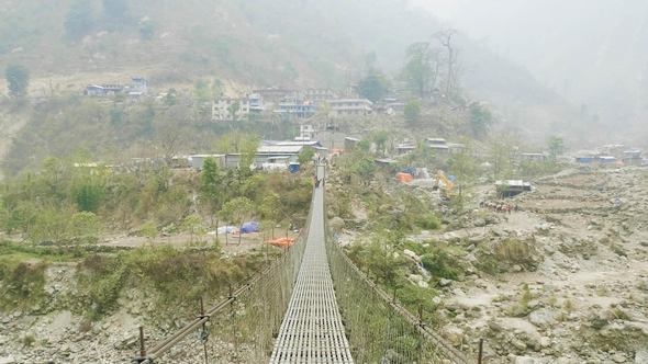 Way To the Village Through the Suspension Bridge Over the River in Nepal.