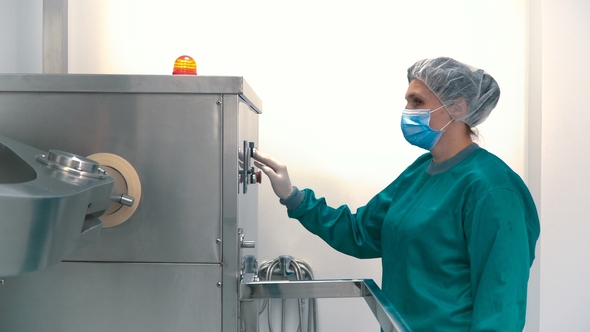 Laboratory Worker Adjust Pharmaceutical Machine for Mixing Powder and Granules alt