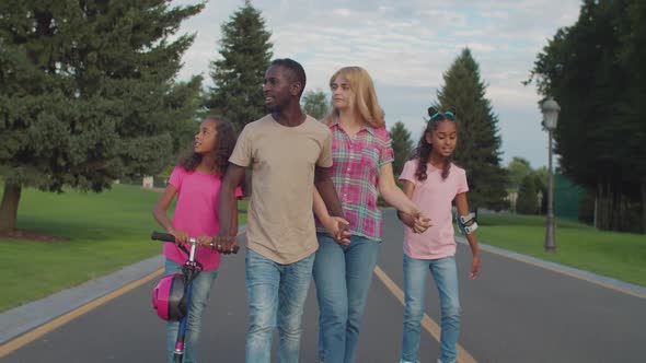 Diverse Family with Girls Enjoying Leisure Outdoor