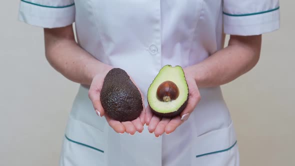 Nutritionist Doctor Healthy Lifestyle Concept - Holding Organic Avocado