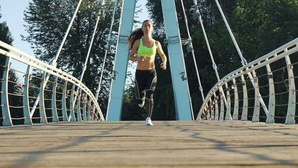 Active Woman Jogging Running on City Footbridge