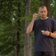 Man Inserts Wireless Headphones in the Park and Listens To Music - VideoHive Item for Sale