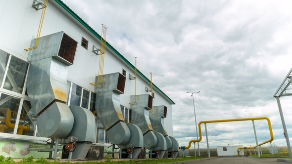 Plant Workshop with Ventilation Tubes Against Clouds