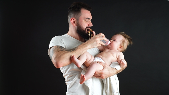 Father Holding and Taking Care of Little Infant Baby