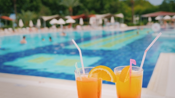 A Luxurious Holiday for Two Lovers Two Glasses with an Orange Cocktail on the Background of a Huge