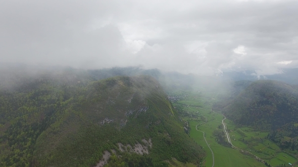 Flying Through Clouds Over Mountains in Slovenia