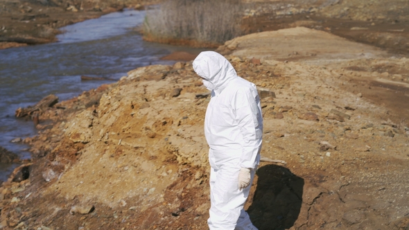 Female Researcher in Protective Clothing Making Experiment in Arid Hazardous Area