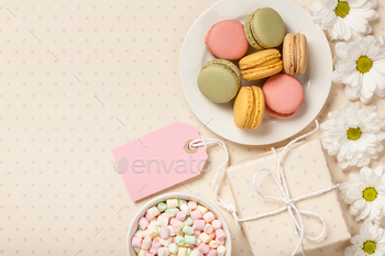 French colorful macaroons, marshmallows, git box and flowers