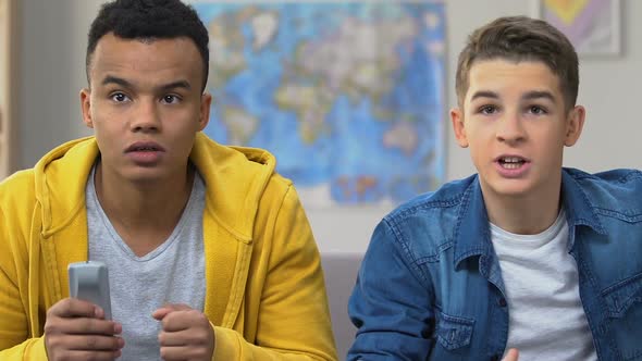 Two Male High School Friends Watching Sports Match on Tv, Championship Team Fans