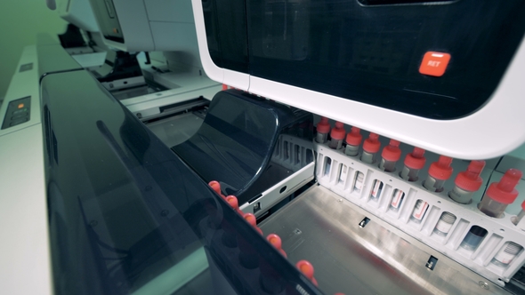 Many Blood Samples Are Checked in a Special Medical Automated Machine, Moving on a Line alt
