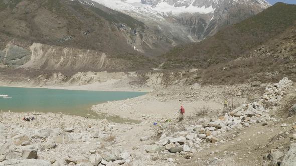 Backpackers on the Mountain Lake Birendra in Nepal