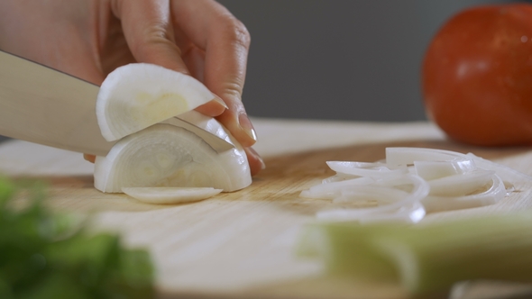 Slicing White Onions in Half Rings for Later Use