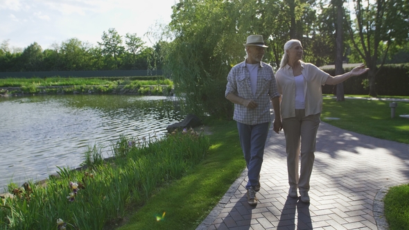 Beautiful Senior Couple Walking in Summer Park