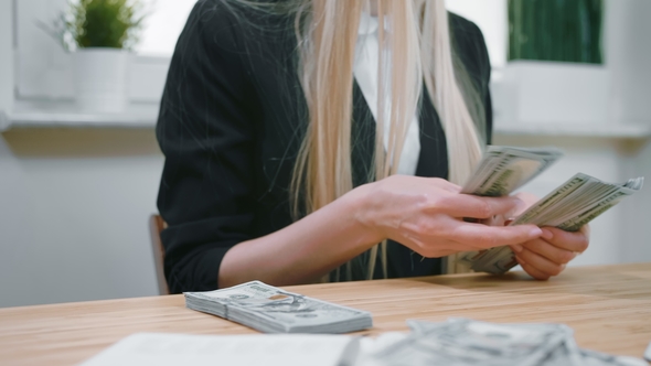 Business Woman Counting Cash in Hands