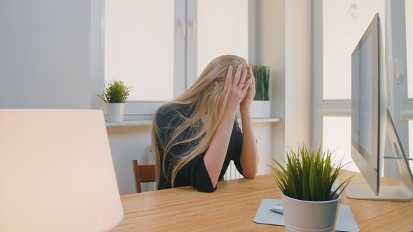 Upset Woman Sitting at Workplace. Blond Sad Female in Elegant Clothes Clutching Head After Failure