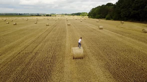 Child Boy In The Field. Child boy in the field against straw bales alt