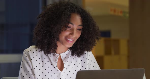 Businesswoman working on laptop in a modern office