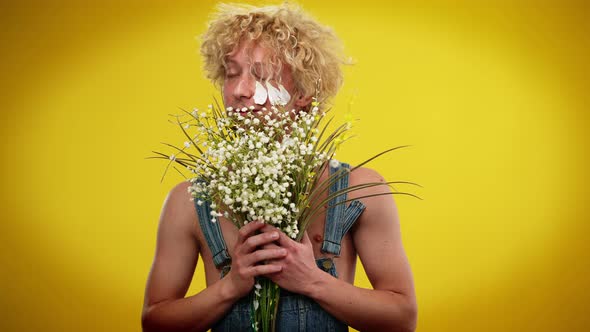 Medium Shot Portrait of Happy Caucasian LGBT Man Posing with Bouquet of White Flowers at Yellow