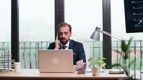 In Modern Office with Big Windows Corporate Worker Talks on the Phone.