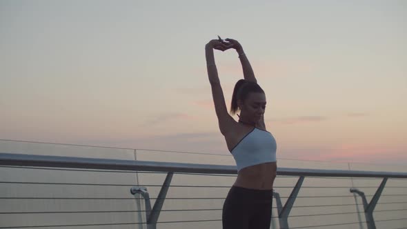 African Female Athlete Warming Up Doing Stretches alt