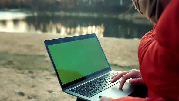 Green screen laptop on the lake sunset