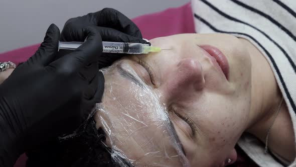 Face mesotherapy procedure in a beauty salon. Beautician doctor makes injections