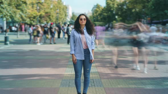 Zoomin Time Lapse Portrait of Serious Asian Girl Standing in Pedestrian Street in Modern City