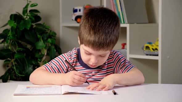 Preschool Child Learns to Write Writes Copybook