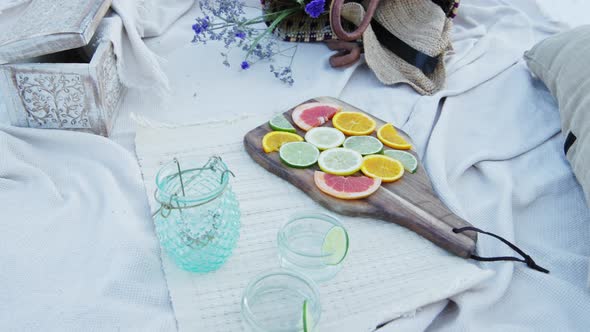 Luxury picnic set up for a romantic date with citrus fruits and accessories at the beach - Close Up 